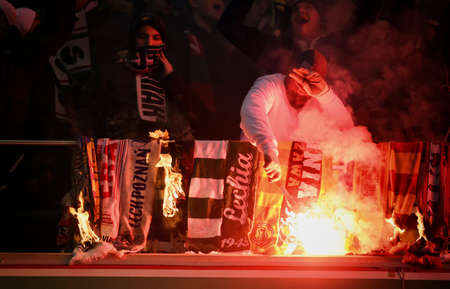 WARSAW, POLAND - NOVEMBER 28, 2021: Polish Football League game Legia Warszawa - Jagiellonia Bialystok, Legia fans set fire to scarves and flags of other clubsのeditorial素材