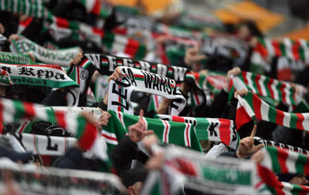 WARSAW, POLAND - DECEMBER 09, 2021: UEFA Europa League group Stage game Legia Warszawa - FC Spartak Moscov, Legia fans with scarvesのeditorial素材