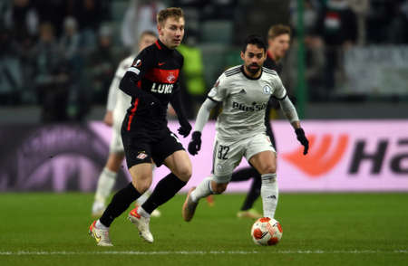 WARSAW, POLAND - DECEMBER 09, 2021: UEFA Europa League group Stage game Legia Warszawa - FC Spartak Moscov, Nail Umyarov (FC Spartak Moskva) Luquinhas (Legia Warsaw)のeditorial素材