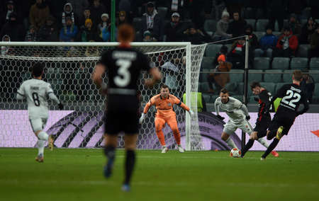 WARSAW, POLAND - DECEMBER 09, 2021: UEFA Europa League group Stage game Legia Warszawa - FC Spartak Moscov, Zelimkhan Bakaev (FC Spartak Moskva) scores a goal, Artur Boruc (Legia Warsaw)のeditorial素材