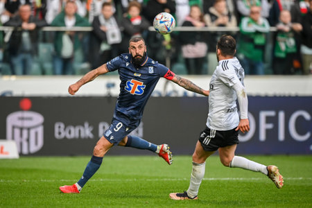 WARSAW, POLAND - APRIL 16, 2023: Polish Football League T-Mobile Ekstraklasa o/p: Mikael Ishak (Lech) Yuri Ribeiro (Legia)のeditorial素材