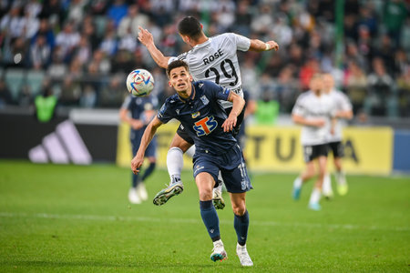 WARSAW, POLAND - APRIL 16, 2023: Polish Football League T-Mobile Ekstraklasa o/p: Filip Marchwinski (Lech) Lindsay Rose (Legia)のeditorial素材