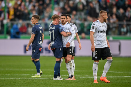 WARSAW, POLAND - APRIL 16, 2023: Polish Football League T-Mobile Ekstraklasa o/p: Michal Skoras (Lech) Yuri Ribeiro (Legia)のeditorial素材