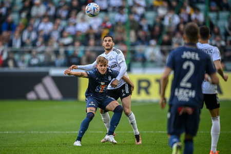 WARSAW, POLAND - APRIL 16, 2023: Polish Football League T-Mobile Ekstraklasa o/p: Yuri Ribeiro (Legia) Michal Skoras (Lech)のeditorial素材