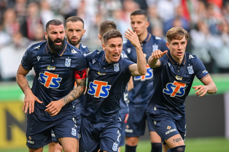 WARSAW, POLAND - APRIL 16, 2023: Polish Football League T-Mobile Ekstraklasa o/p: Alfonso Sousa (Lech) goal celebration with Mikael Ishak (Lech)のeditorial素材