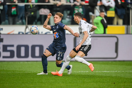 WARSAW, POLAND - APRIL 16, 2023: Polish Football League T-Mobile Ekstraklasa o/p: Michal Skoras (Lech) Filip Mladenovic (Legia)のeditorial素材