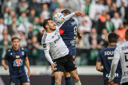 WARSAW, POLAND - APRIL 16, 2023: Polish Football League T-Mobile Ekstraklasa o/p: Yuri Ribeiro (Legia) Mikael Ishak (Lech)のeditorial素材