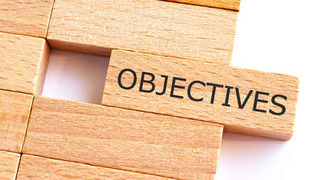 Objectives written on wood blocks. Business concept.A piece of wood with text OBJECTIVES.