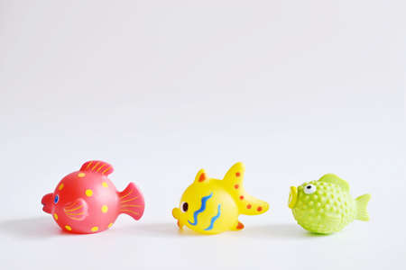Multi-colored rubber toy fish on a white background.の写真素材