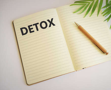 Detox word written in notebook.Healthcare concept. Digital detox as disconnected internet life style concept.Free space for text. Copy space. Top view.の写真素材