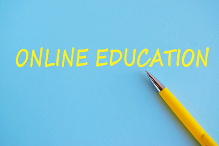 Conceptual hand writing showing Online Education. Business photo showcasing kind of learning that takes place via the Internet. Yellow text and briht blue background.の写真素材