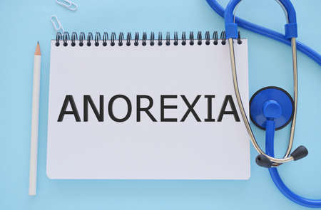 Anorexia text written in notebook. Concept image. Anorexia syndromesの写真素材
