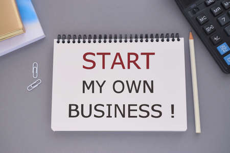 Start My Own Business text written in Notebook, Business concept, gray background, Pencil, Notebook...