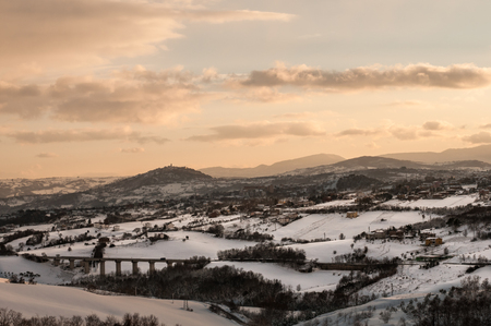 sunset view of Ferrazzano and Campobasso, Italy, during winter after a snowfallの写真素材