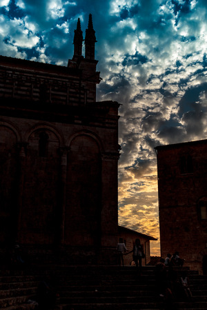 italian beautiful sunset and view of bell tower and cathedral Massa Marittima Tuscanyのeditorial素材