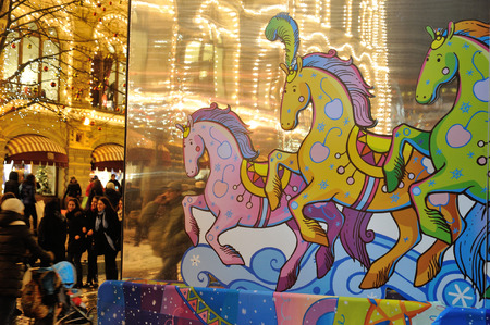 MOSCOW - DECEMBER 21: Drawn horse, illumination and people walking befor New Year near GUM building on December 21, 2014 in Moscow.のeditorial素材