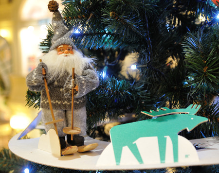 MOSCOW - DECEMBER 21: Santa Claus toy and reindeer toy against the Christmas tree in the GUM store on December 21, 2014 in Moscow.のeditorial素材