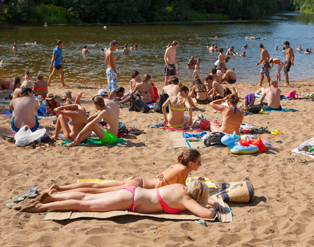 MOSCOW - AUGUST 03: People sunbathing and swimming in Moskva river beach at Serebryany Bor Park on August 3, 2014 in Moskva. Serebryany Bor is the large forest park in North-west Moscow.のeditorial素材