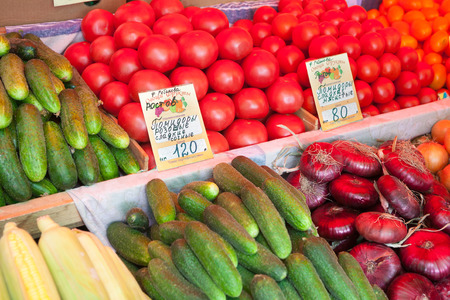 MOSCOW - AUGUST 08: Cucumbers, tomatoes, onions at Vegetable Fair counter on Leskov Street on August 8, 2014 in Moscow.のeditorial素材