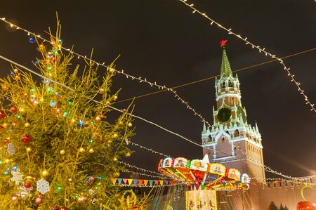 MOSCOW, RUSSIA - DECEMBER 12, 2018: New Year's Christmas tree, illumination, and Moscow Kremlin Spasskaya Tower in Red Square on winter night.のeditorial素材
