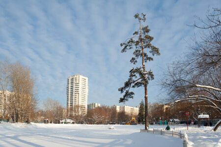MOSCOW, RUSSIA - JANUARY 09, 2019: Pond covered with snow, trees in Lianozovo park and residential buildings in Cherepovets street on sunny winter day. Cherepovetskaya street is located in North of Moscow.のeditorial素材