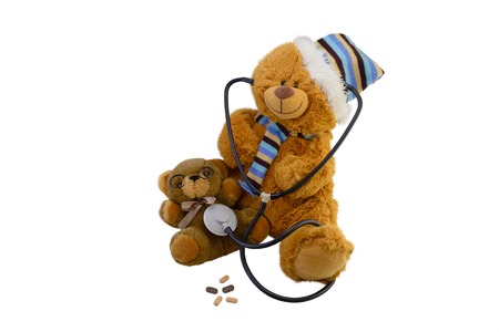 isolate macro composition a children's toy the teddy bear measures by a stethoscope heartbeat at a little teddy bearの写真素材