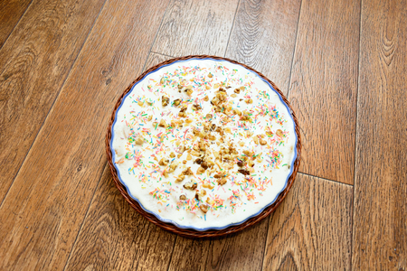 macro cake of house preparation with topping in a dish on a wooden backgroundの写真素材