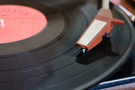ancient player of vinyl records with a plate and the sound receiver macro isolate a white backgroundの写真素材