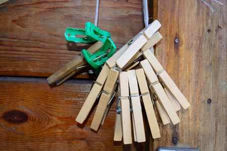 old wooden and plastic clothespegs on a rope opposite to a wooden doorの写真素材
