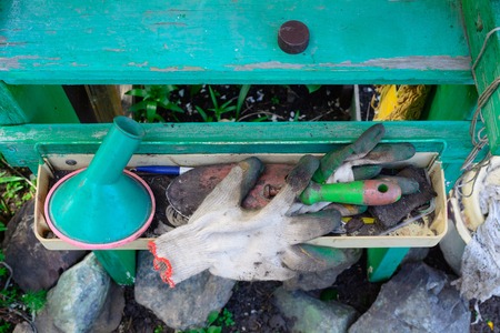 stand, shelf for garden accessories, tools. is in the yard of a garden
