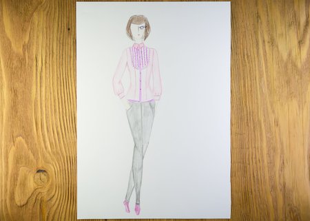 the drawing of designer clothes pencils on paper. background wooden table.の写真素材