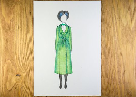 the drawing of designer clothes pencils on paper. background wooden table.の写真素材