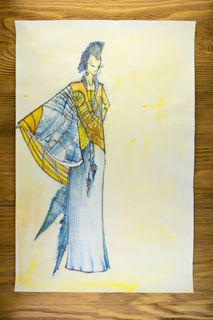 the drawing of designer clothes pencils on paper. background wooden table.の写真素材