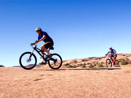 Father and son mountain bike near Moab, Utahの写真素材