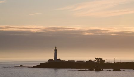 A Pacific Coast Lighthouse at Sunset with Cloudsの写真素材