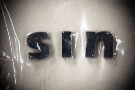 Letters for the Word Sin under Plastic Wrap - Grungeの写真素材