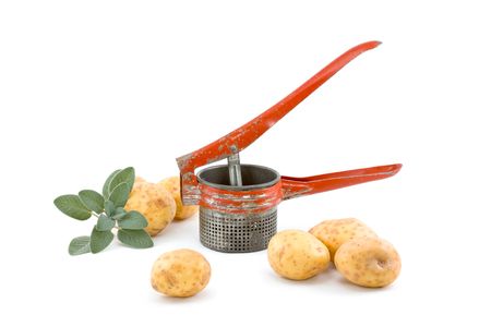 Potatoes with Vintage Ricer and Sage on Whiteの写真素材