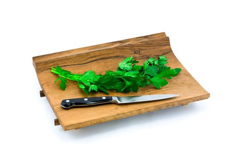 Italian Parsley on Cutting Board with Knife in White Backgroundの写真素材