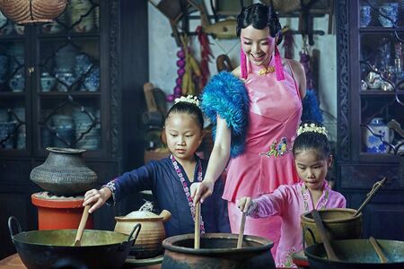 Penang,Malaysia-October 6th,2018:A beautiful adult model posing with two young girls wearing traditional Chinese clothing.Chinese traditional clothing and house can be found in Peranakan Mansion in Penang.のeditorial素材