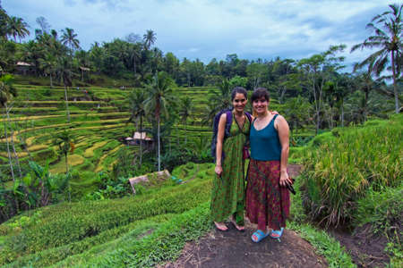 Tegalalang, Bali - November 24th, 2017: Two female traveller from Chile taking photong with the paddy field as the background. Tegalalang paddy field is one of the famous tourist spot.のeditorial素材