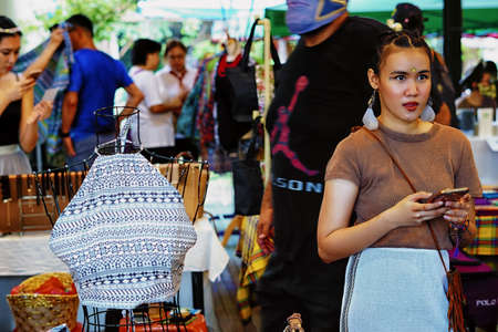 Penang,Malaysia-October 28th,2018:A beautiful girl prpromoting her clothing for sale at Hin Bus Depot market.This market operates every Sunday from morning till evening.のeditorial素材