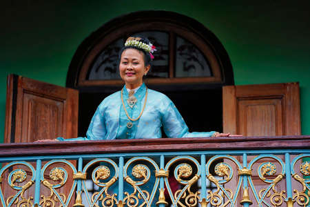 Penang,Malaysia-October 6th,2018:A beautiful middle age lady posing in front of a Pinang Peranakan Mansion balcony.This mansion preserve the originality of its design to show it to the tourist.のeditorial素材