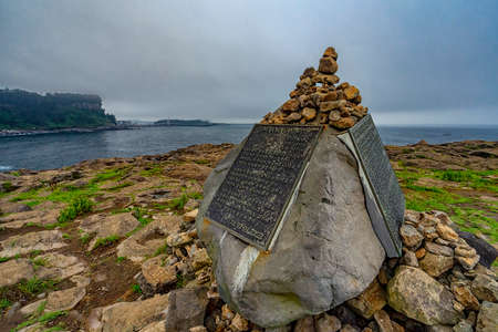 Jeju,South Korea-July 26th,2019:A big rock with written plate regarding the history on this location in Korean during thick fog condition.This is one of the tourist spot in Jeju.のeditorial素材