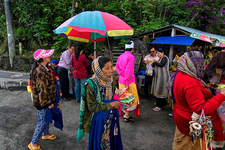 Mount Batur, Bali - November 24th, 2017: Group of women tried to sell souvenir to the tourist. Balinese believe men are superior and women are suppose to work for a livingのeditorial素材