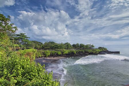 Great nature view of a beach in Tanah Lot Bali with heavy waves hitting the beachの写真素材