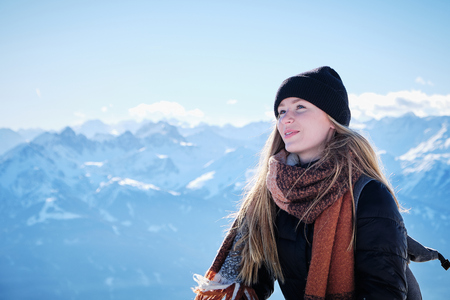 Portrait of blonde long hair girl with blue eyes in the mountain summit Hafelekar near Innsbruckの写真素材