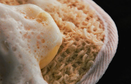 Close up of sponge for cleaning on black background, selective focus.の写真素材