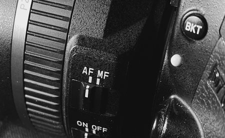 Close up of a SLR camera. Black and white photo.