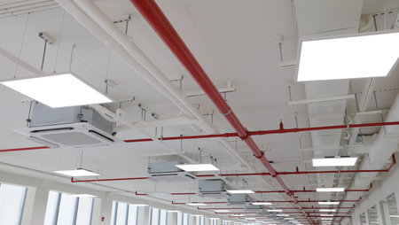 Interior of a modern office building with white ceiling and red ceiling
