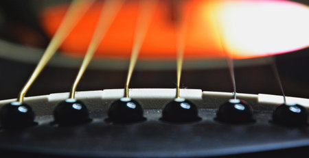 Close up of acoustic guitar strings, shallow depth of field, selective focus